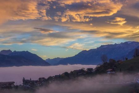 Autumn sea of fog with sunrise at Camping Stuhlegg in Krattigen near Interlaken Switzerland
